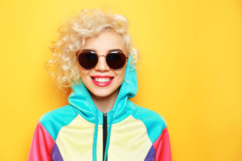 Fashion girl in sportswear on yellow background